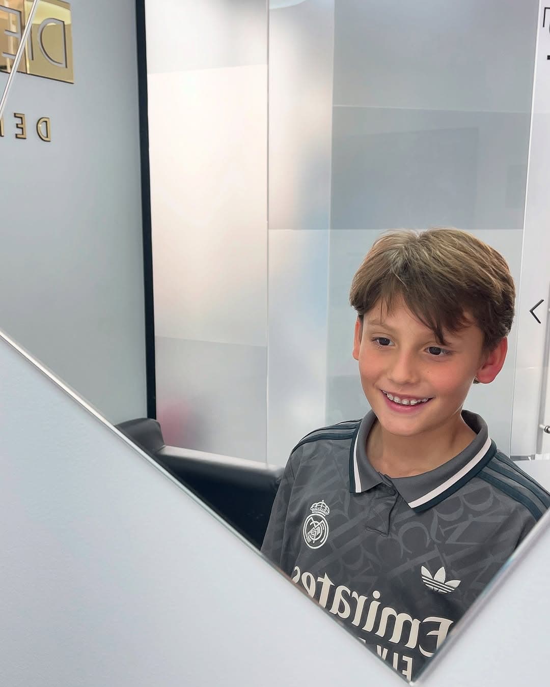 Niño sonriendo frente al espejo del consultorio
